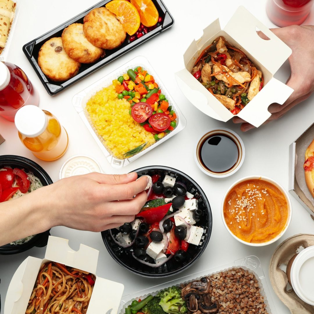 People eat takeaway. Food delivery. Tasty food on white table